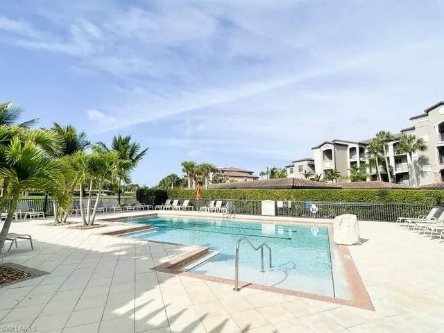 a view of swimming pool with outdoor seating and plants