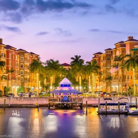 a multi story building with swimming pool and lake view
