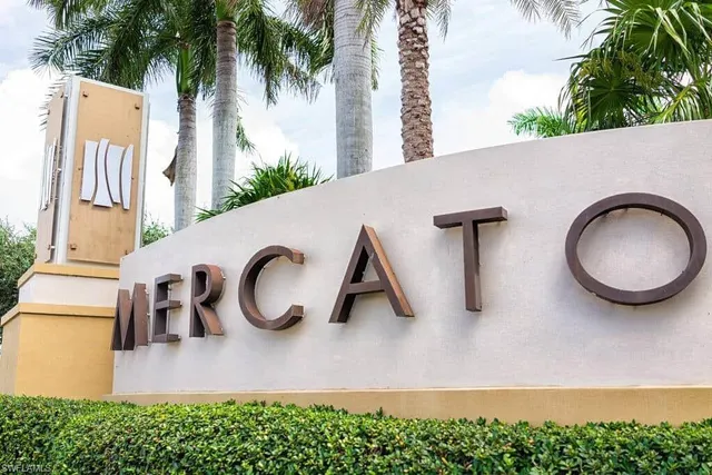 a backyard of a house with large trees and plants