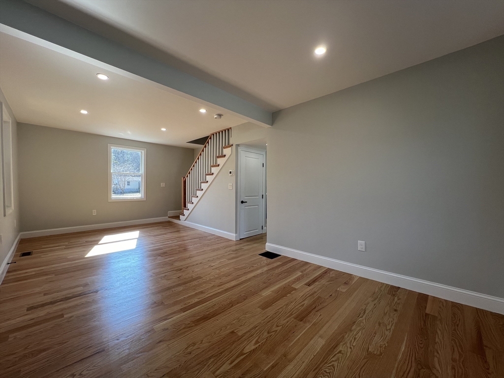 136 Old Bolton Road Stow, MA 01775 - Photo 12 of 34 an empty room with wooden floor and windows