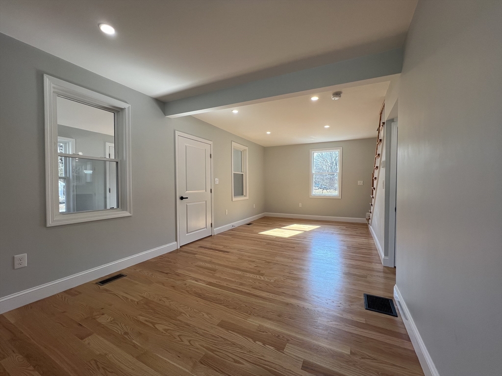 136 Old Bolton Road Stow, MA 01775 - Photo 13 of 34 a view of empty room with wooden floor and fan