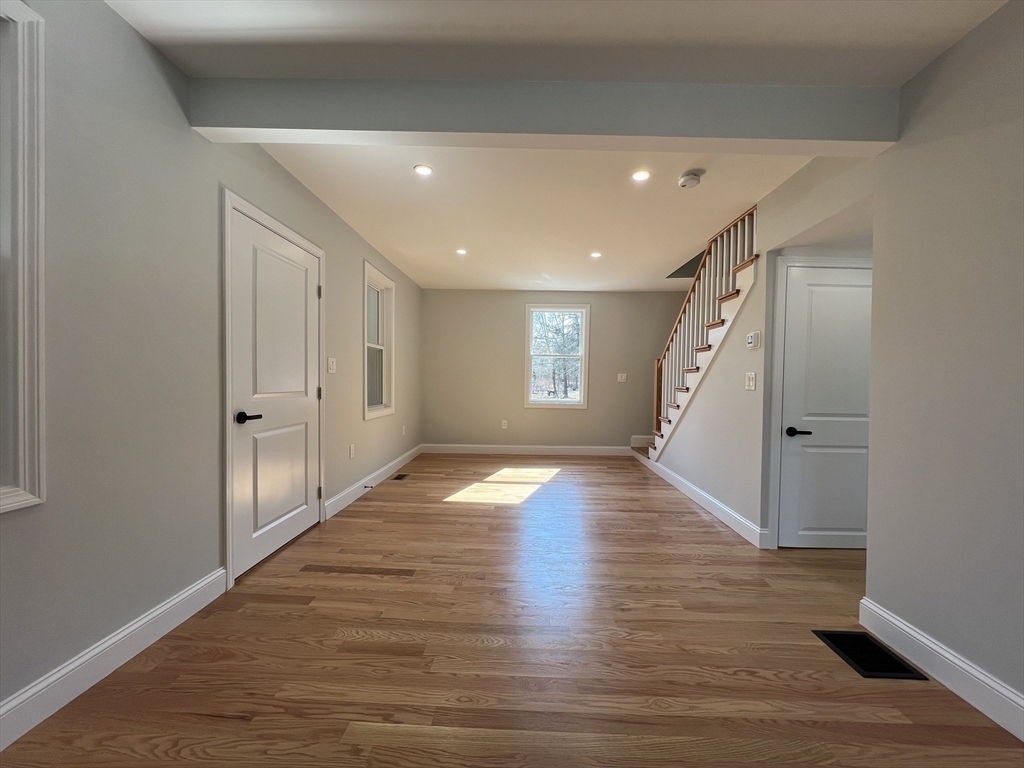 136 Old Bolton Road Stow, MA 01775 - Photo 14 of 34 a view of empty room with wooden floor and window