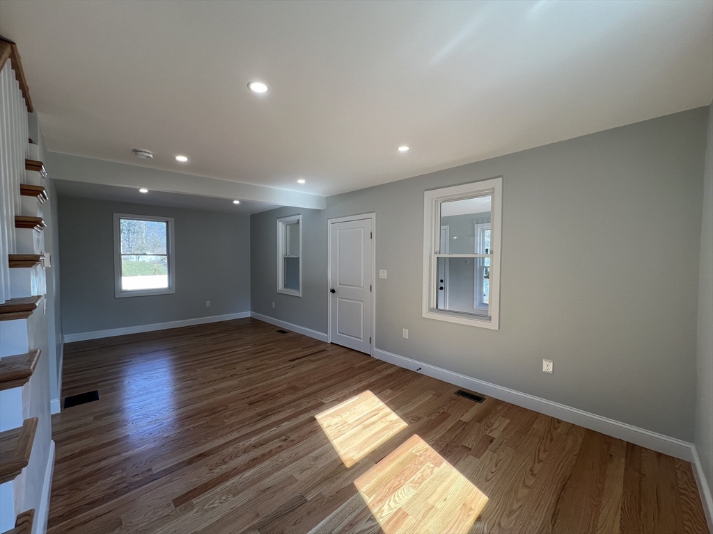 136 Old Bolton Road Stow, MA 01775 - Photo 15 of 34 a view of empty room with wooden floor and fan