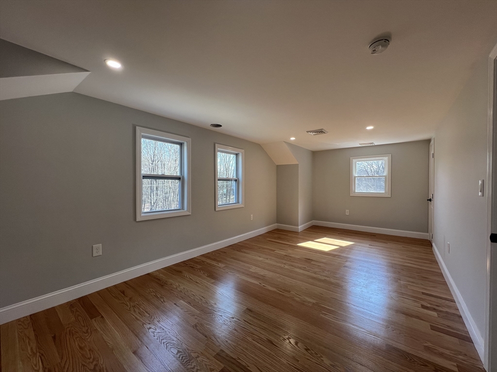 136 Old Bolton Road Stow, MA 01775 - Photo 17 of 34 a view of an empty room with wooden floor and a window