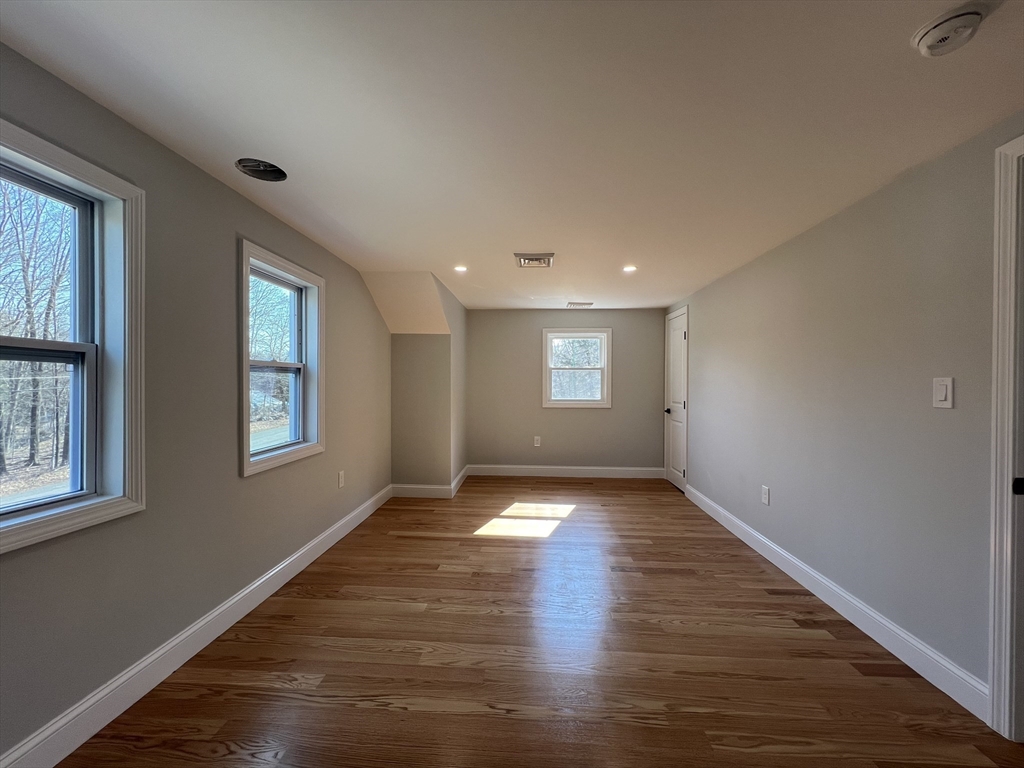 136 Old Bolton Road Stow, MA 01775 - Photo 18 of 34 a view of an empty room with wooden floor and a window