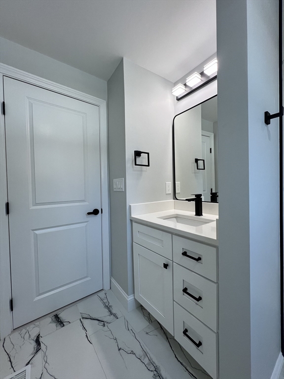 136 Old Bolton Road Stow, MA 01775 - Photo 23 of 34 a bathroom with a double vanity sink and mirror