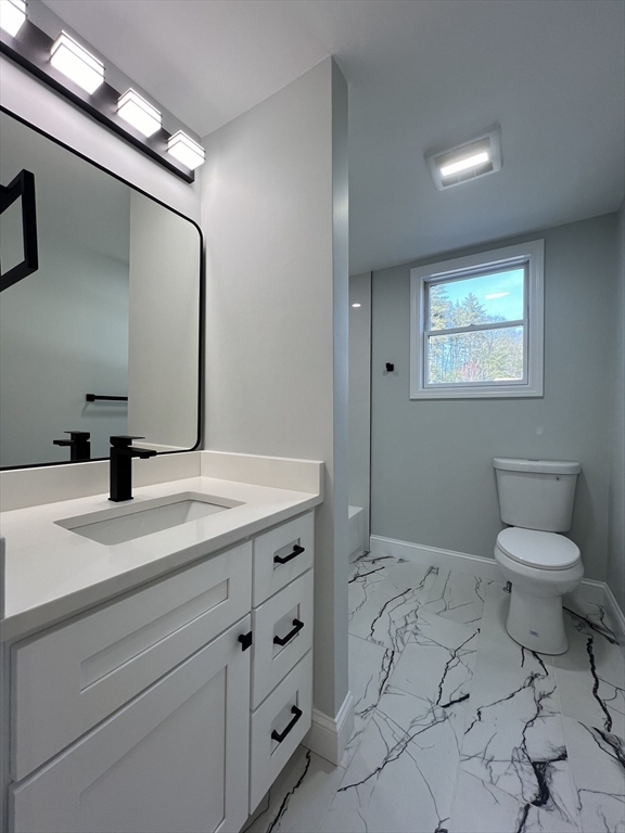 136 Old Bolton Road Stow, MA 01775 - Photo 24 of 34 a bathroom with a toilet sink and mirror