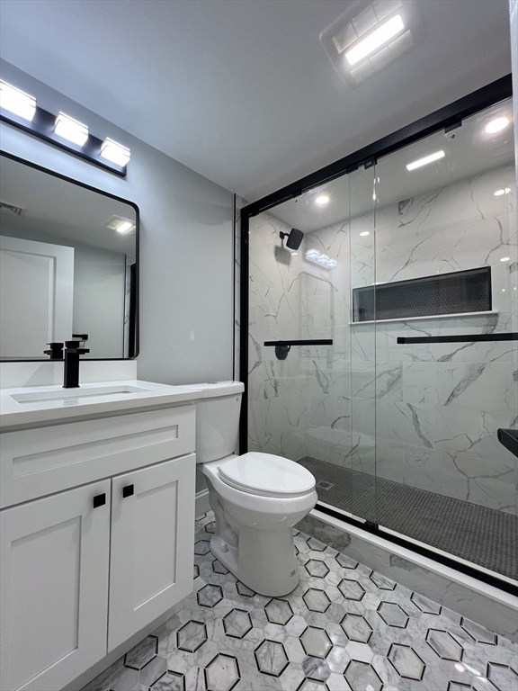 136 Old Bolton Road Stow, MA 01775 - Photo 26 of 34 a bathroom with a toilet sink and a mirror