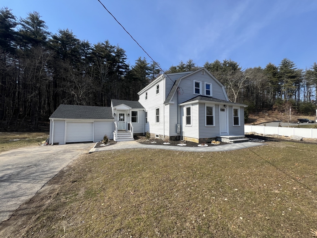 136 Old Bolton Road Stow, MA 01775 - Photo 3 of 34 a view of a white house with a road and yard