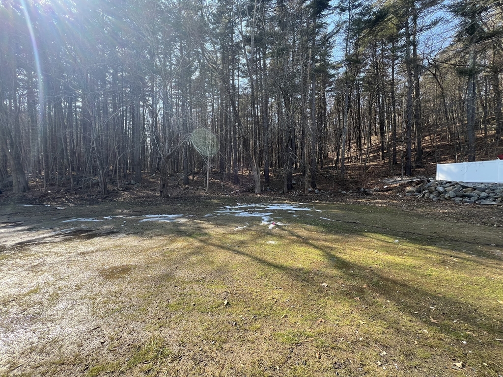 136 Old Bolton Road Stow, MA 01775 - Photo 31 of 34 a view of a house with large trees and covered with wooden fence