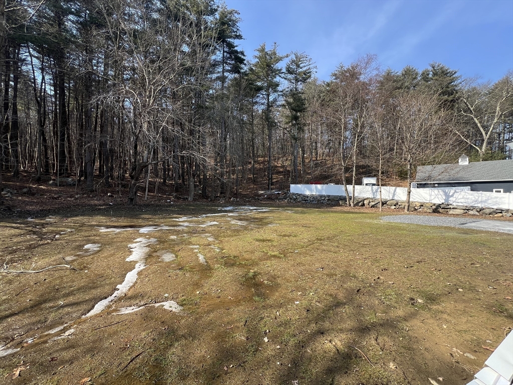 136 Old Bolton Road Stow, MA 01775 - Photo 32 of 34 a view of a house with pool and trees in the background
