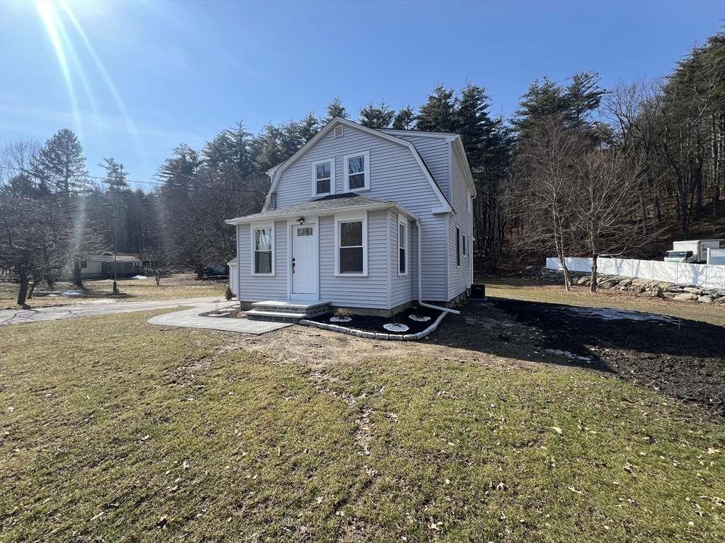 136 Old Bolton Road Stow, MA 01775 - Photo 4 of 34 a view of a house with a yard covered in snow