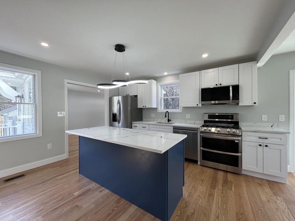 136 Old Bolton Road Stow, MA 01775 - Photo 8 of 34 a kitchen with stainless steel appliances granite countertop a sink stove and oven