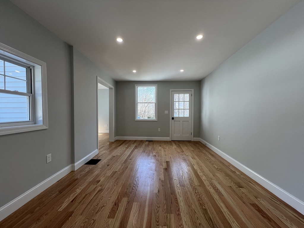 136 Old Bolton Road Stow, MA 01775 - Photo 10 of 34 a view of an empty room with wooden floor and window