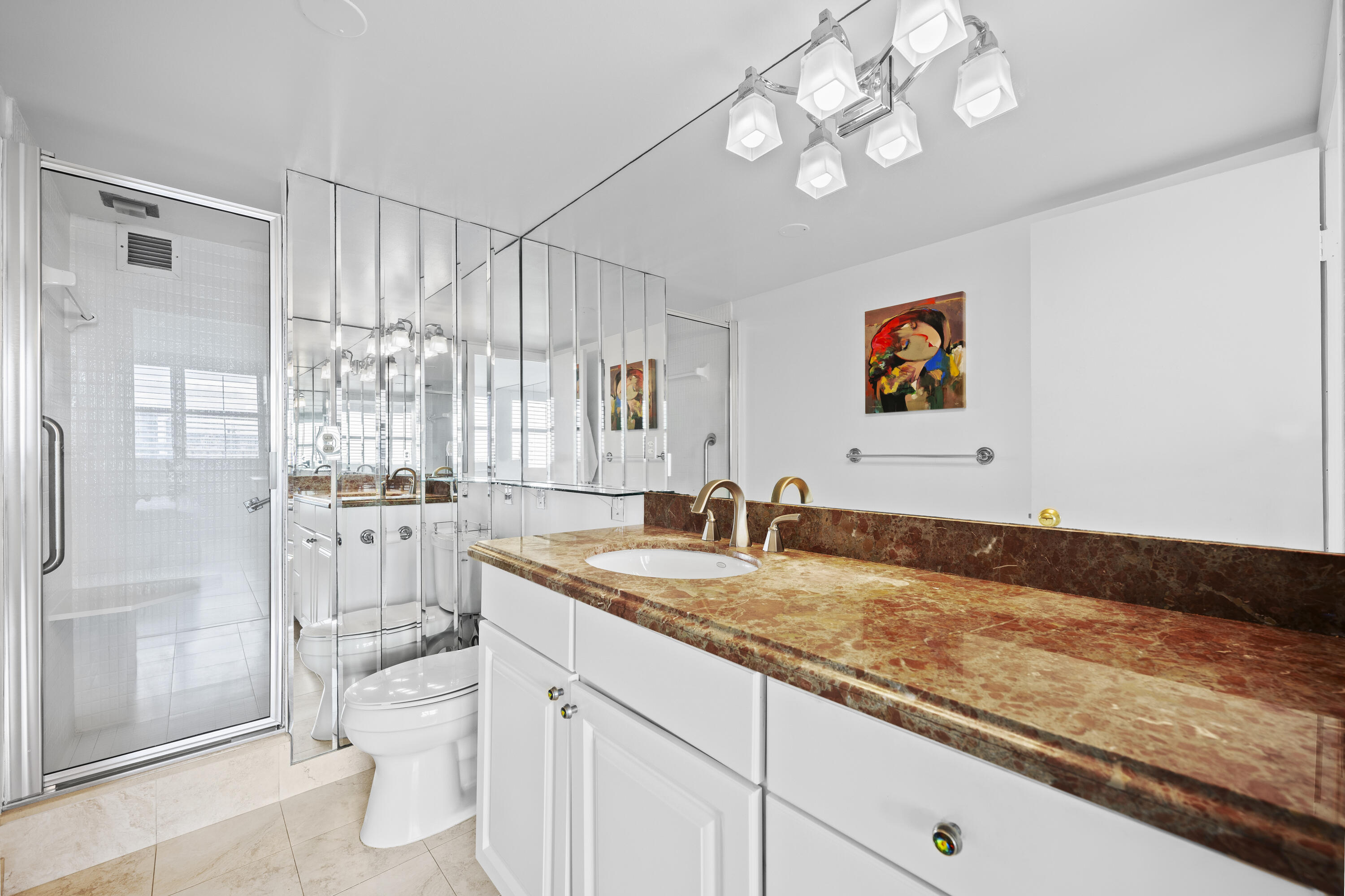 2600 North Flagler Drive, Unit 1007 West Palm Beach, FL 33407 - Photo 11 of 26 a bathroom with a granite countertop sink mirror vanity and toilet