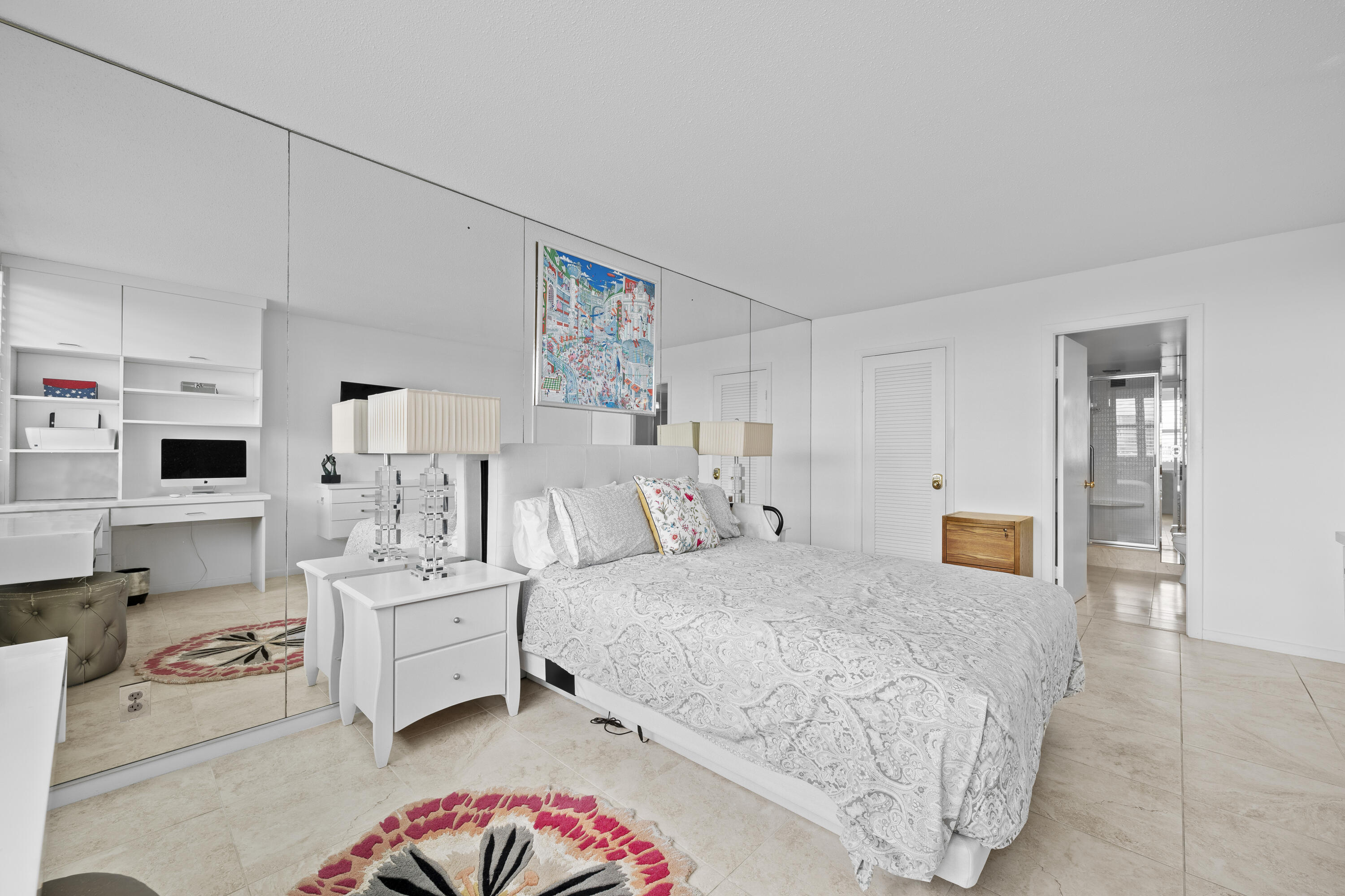 2600 North Flagler Drive, Unit 1007 West Palm Beach, FL 33407 - Photo 12 of 26 a bedroom with a bed and a lamp on the dresser