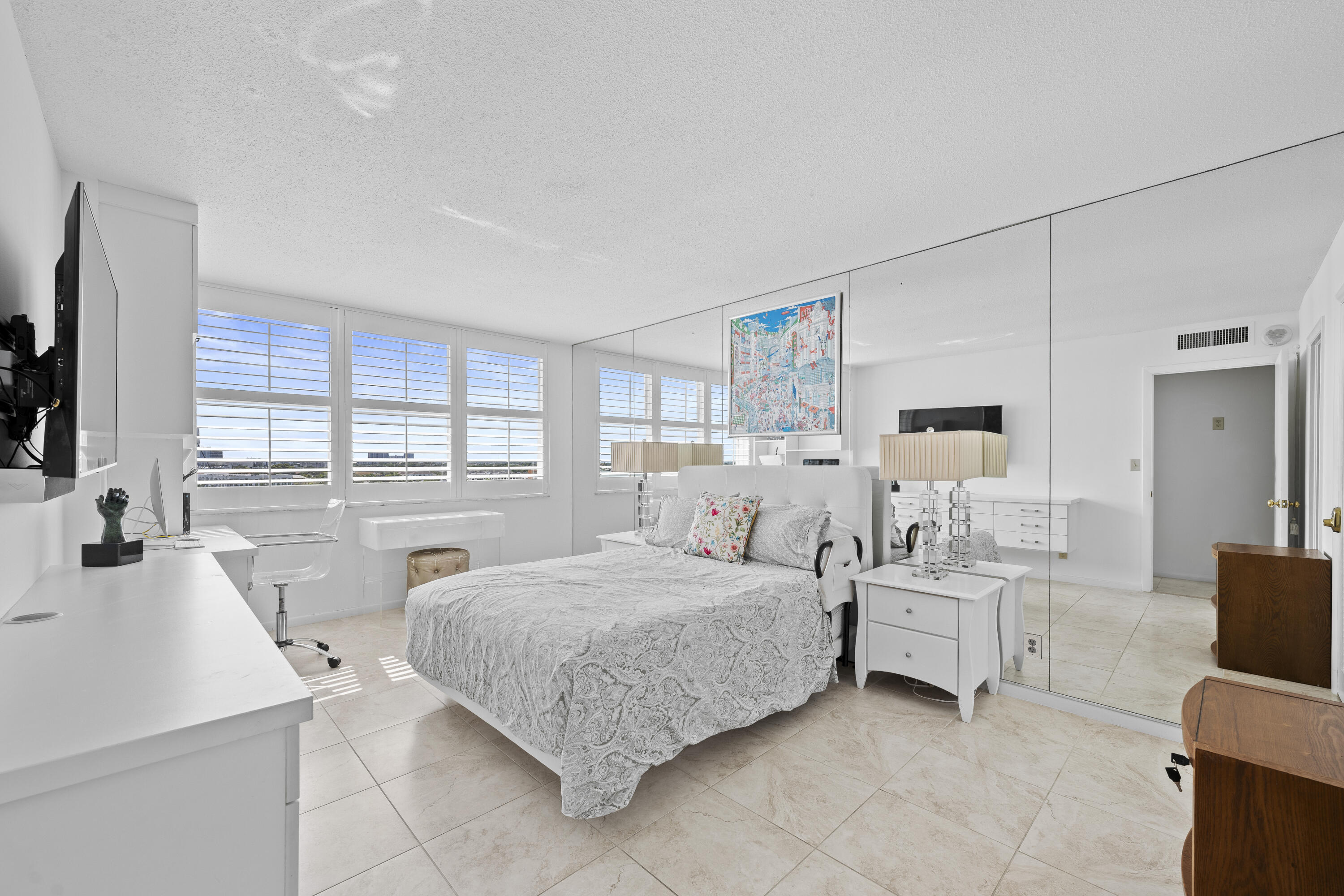 2600 North Flagler Drive, Unit 1007 West Palm Beach, FL 33407 - Photo 13 of 26 a bed room with a bed and a chair