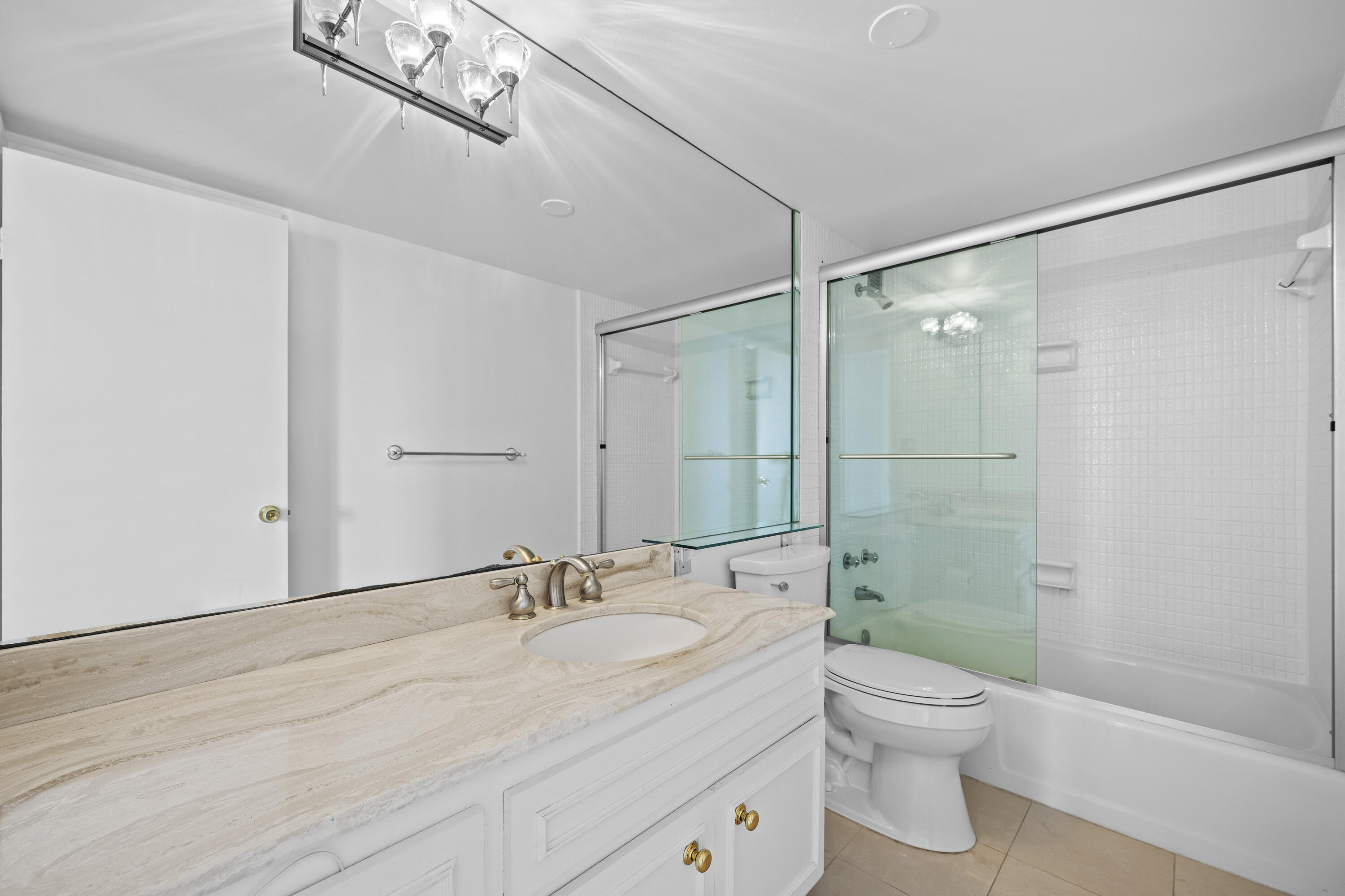 2600 North Flagler Drive, Unit 1007 West Palm Beach, FL 33407 - Photo 14 of 26 a bathroom with a sink a toilet and shower