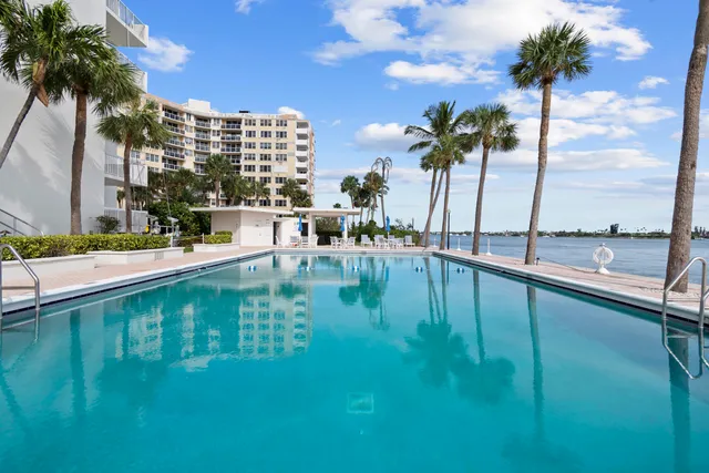a view of swimming pool with outdoor seating and lake view