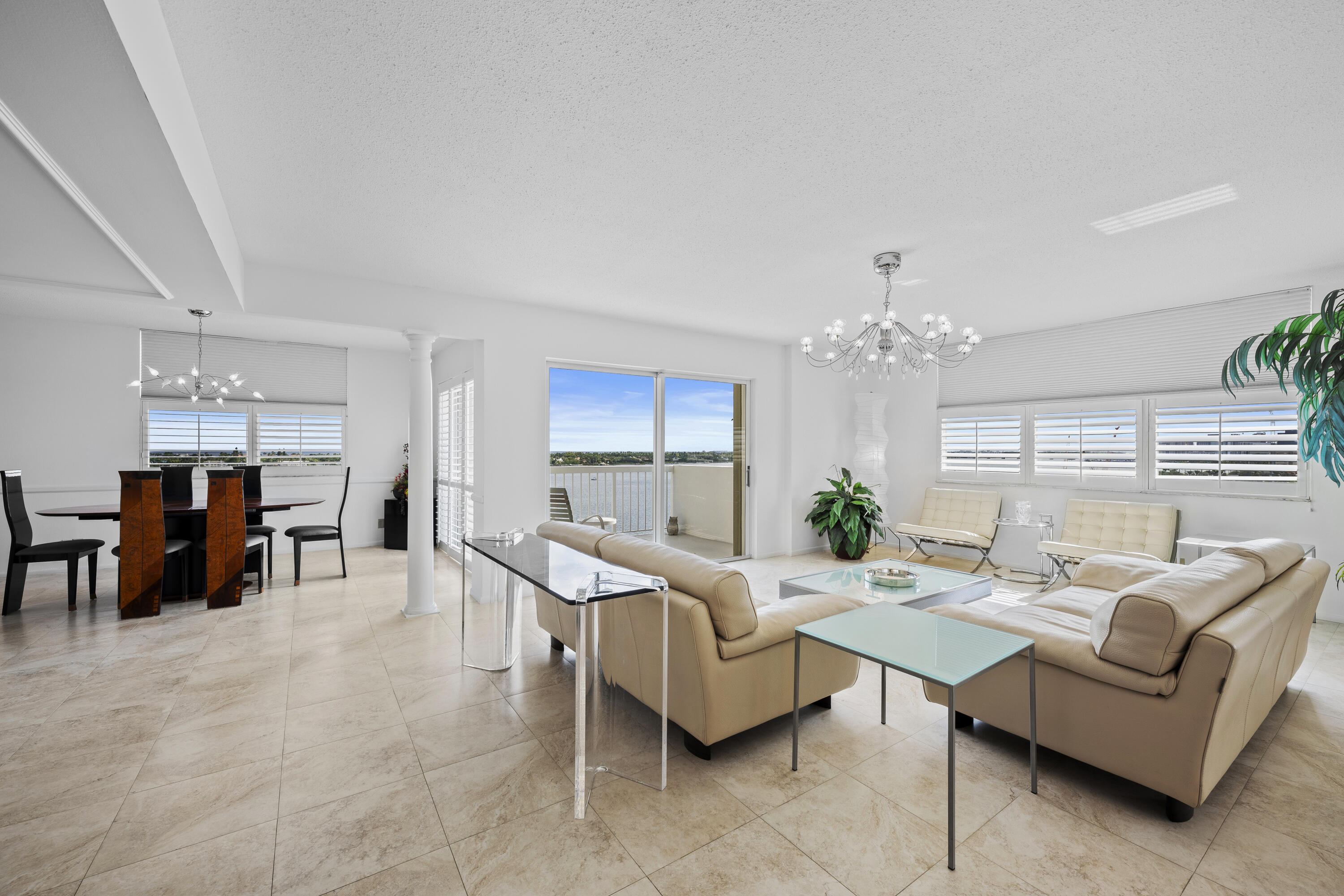 2600 North Flagler Drive, Unit 1007 West Palm Beach, FL 33407 - Photo 2 of 26 a living room with furniture and a chandelier