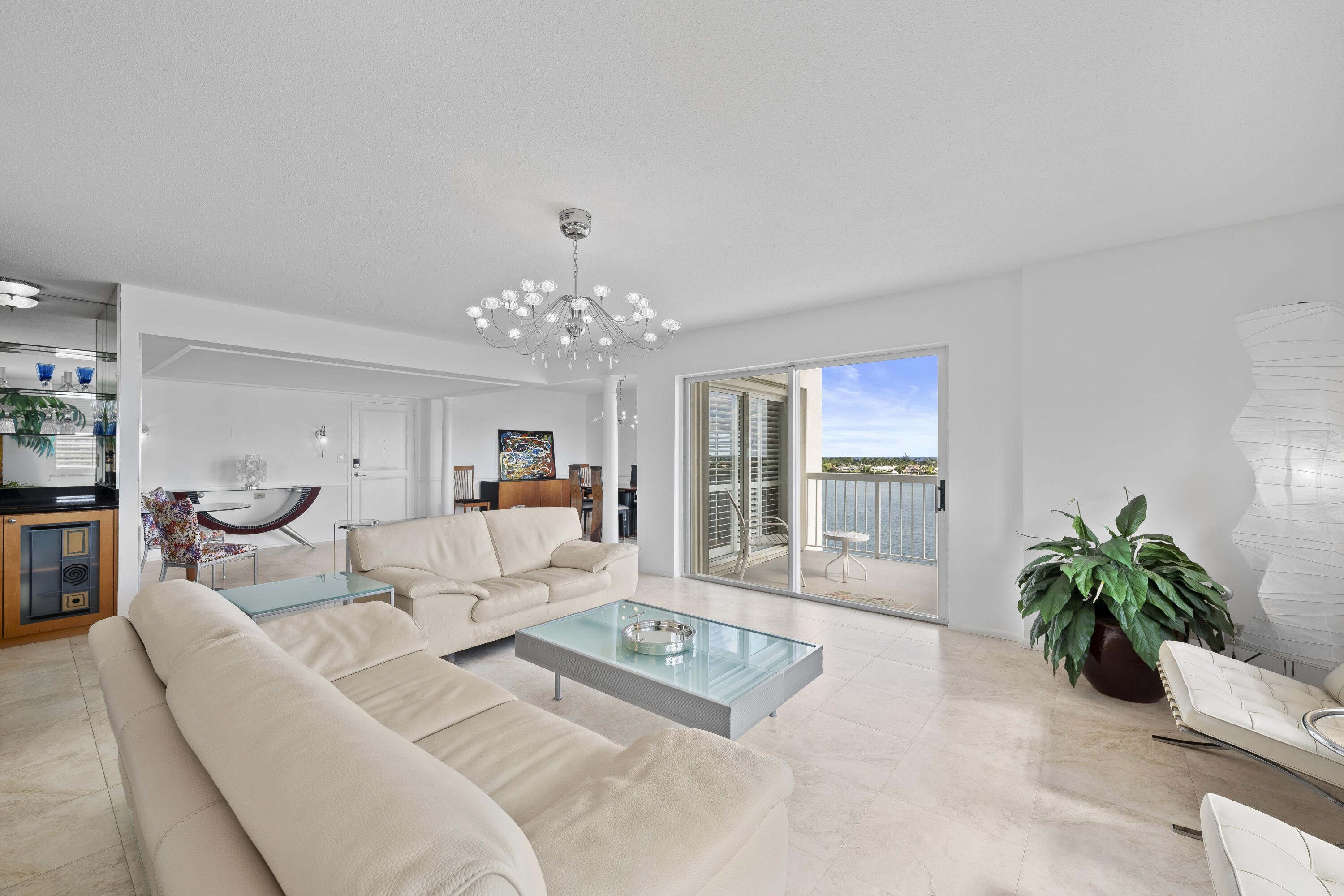2600 North Flagler Drive, Unit 1007 West Palm Beach, FL 33407 - Photo 3 of 26 a living room with furniture and a chandelier
