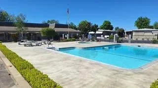 a swimming pool with outdoor seating and yard