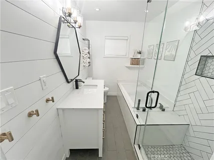 a bathroom with a sink a mirror and shower
