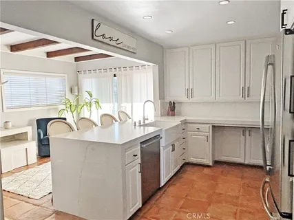 a kitchen with sink a stove and cabinets