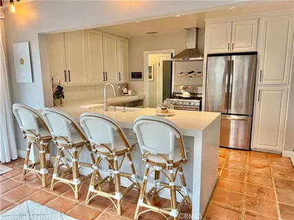 a kitchen with stainless steel appliances a refrigerator and a stove