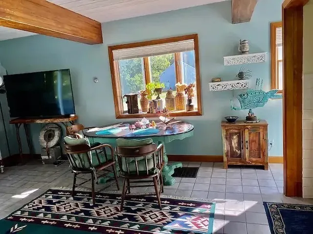 a dining room with furniture and a flat screen tv
