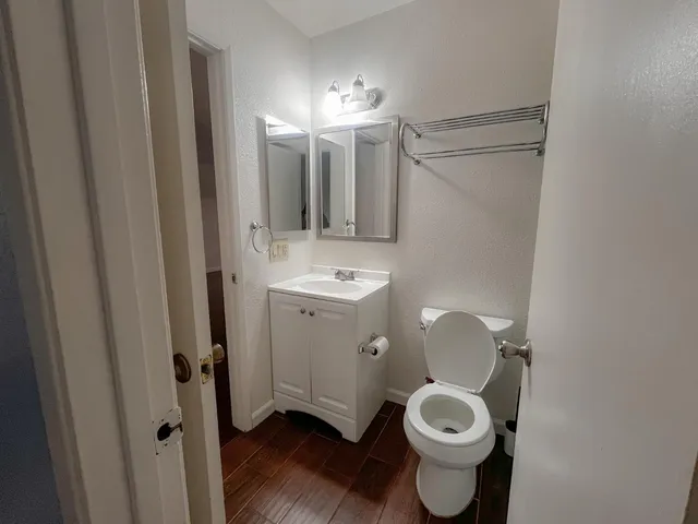 a bathroom with a toilet sink and mirror