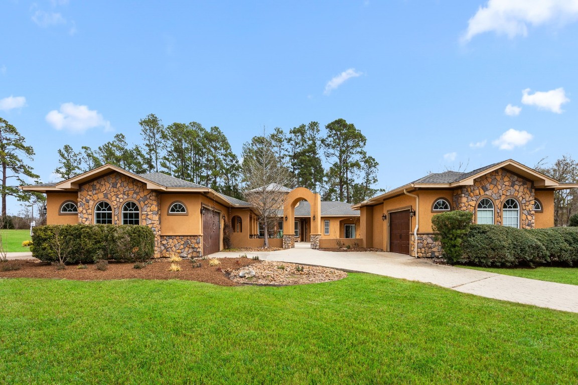 a front view of house with yard and green space