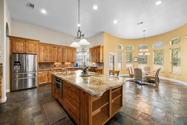 a kitchen with stainless steel appliances granite countertop a stove and refrigerator