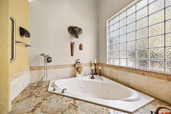 a bathroom with a tub and a shower