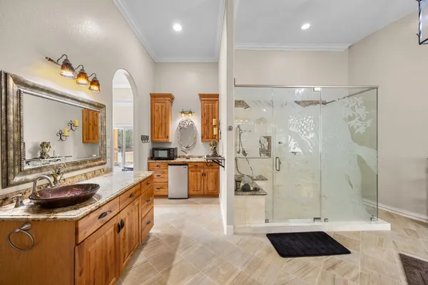 a bathroom with a tub a sink shower and mirror