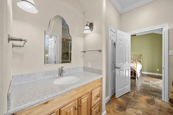 a bathroom with sink shower and a mirror