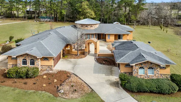 an aerial view of a house with swimming pool garden and patio