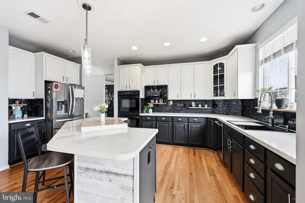 a kitchen with stainless steel appliances kitchen island granite countertop a sink and cabinets
