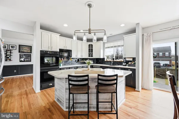 a large kitchen with a table and chairs