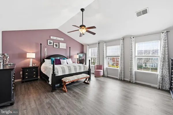 a bedroom with a bed chandelier and window