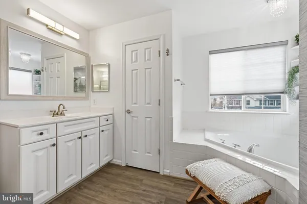 a bathroom with a sink mirror and a toilet