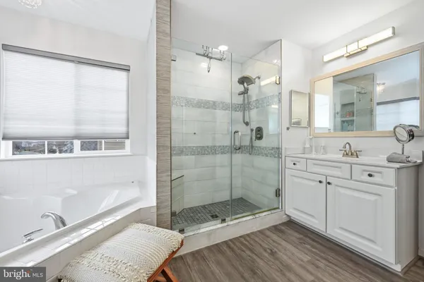 a bathroom with a shower sink and mirror