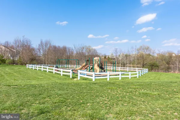 a view of a lake with houses in back