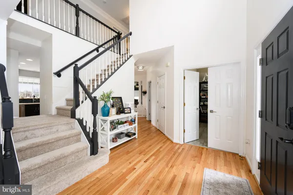 a view of entryway livingroom and hall with wooden floor