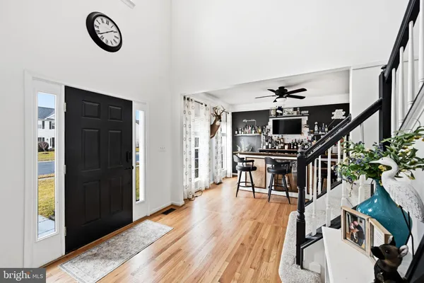 a view of entryway livingroom and hall with wooden floor