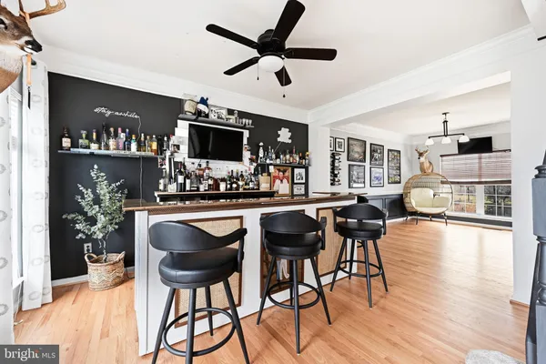 a dining room with furniture and wooden floor