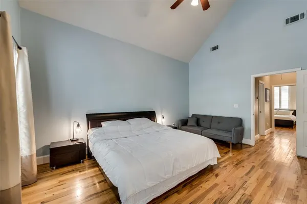 a bedroom with two beds and a couch