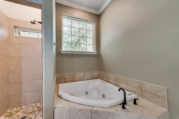 a bathroom with a tub and shower