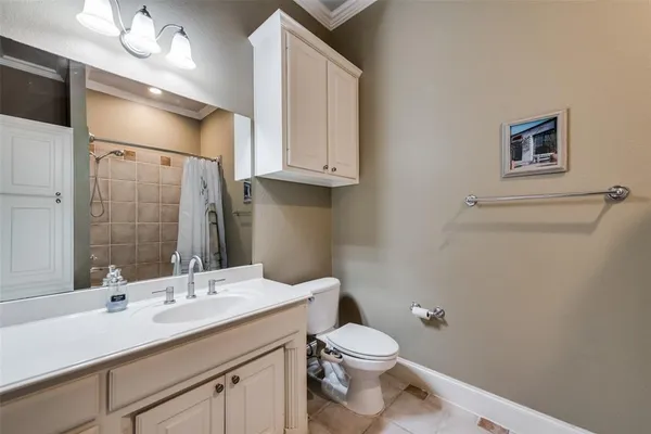 a bathroom with a toilet sink a mirror and vanity