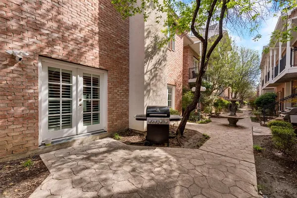a view of a patio with table and chairs and potted plants